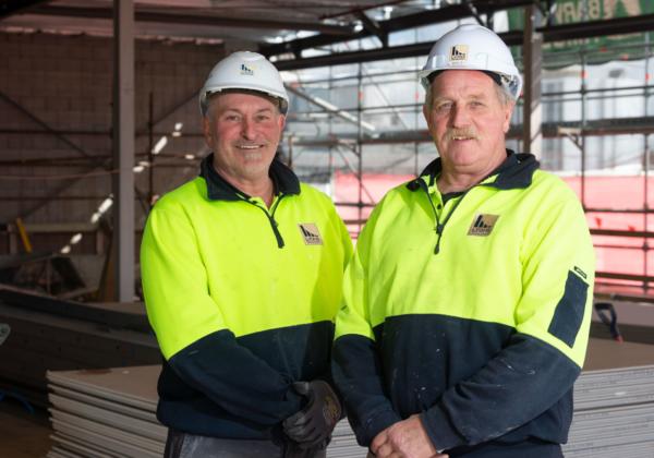 Two Lyons Construction Team Members standing outside