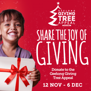 Child with a gift for the Bethany Giving Tree Appeal